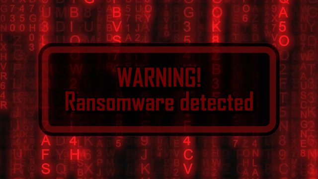 The text Warning, Ransomware Detected, appearing on a board over random symbols falling down (code rain, a popular sci-fi movie effect), changing their color from green to red.
