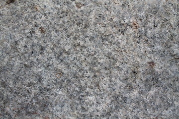 Granite rock closeup background, stone texture, cracked surface