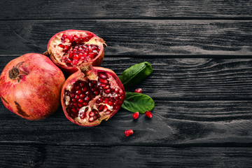 Pomegranate. Fresh fruits. On a wooden background. Top view. Free space for text.