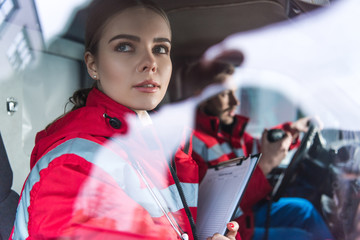 Young paramedic sitting in ambulance and looking away © LIGHTFIELD STUDIOS