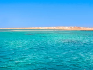 Deurstickers Background of Sharm el Sheikh, Sinai Peninsula, Egypt. Blue sea of Ras Mohammed National Park with its clear and transparent waters and its famous reef. Copy space. Summer holidays. Horizontal shot. © bennymarty