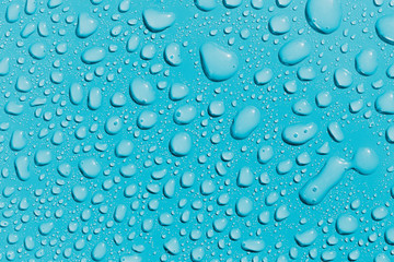Surface with water drops, light blue background