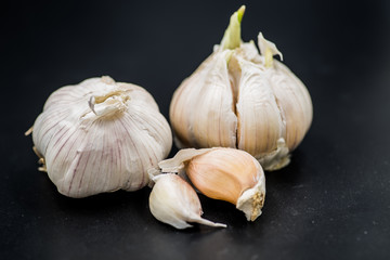 garlic cloves isolated on black background