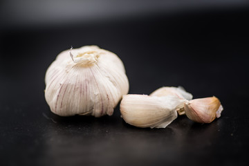 garlic cloves isolated on black background