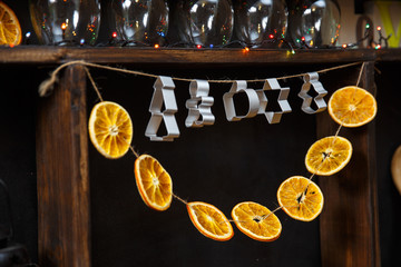 Fototapeta na wymiar Dried oranges and cookie shapes with a Christmas lights