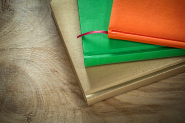 Office closed notebooks on wooden board
