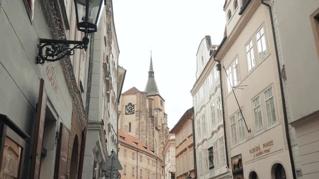 View of a Medieval Narrow European Street With Balconies And a Chapel At The End of The Street