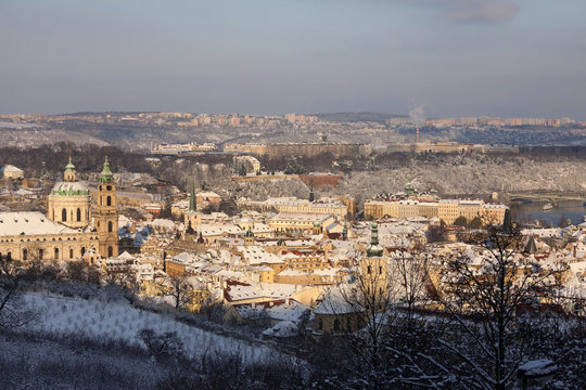 Christmas snowy Prague Lesser Town with St. Nicholas' Cathedral, Czech republic