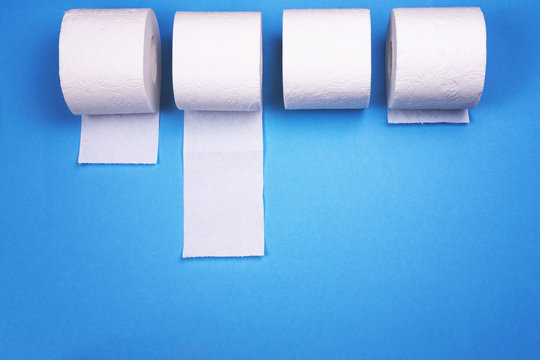 A few rolls of toilet paper on a bright colored background.