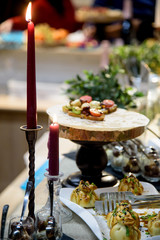 Sweet mini donuts and red candles on table, buffet breakfast, some festival