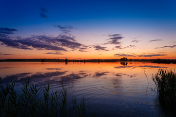 Evening trip. Summer sunset above the lake.
