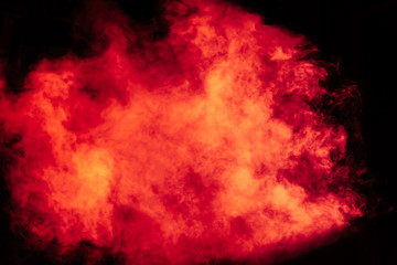 Obraz premium Red and yellow theatrical smoke on stage. Lighting equipment.