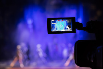 Filming the show from the auditorium. LCD viewfinder on the camcorder. Theatrical performance. The...