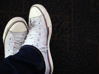 White sneakers prepared to walk with on background.