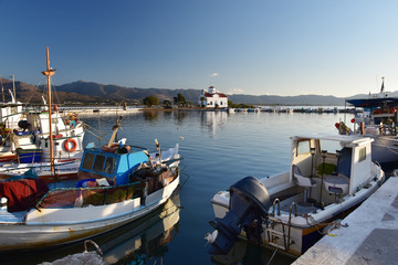 Fototapeta premium Peaceful morning on Elafonisos Island, Greece. The port of Elafonisos with view to Saint Spyridon church built on a small islet