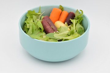 Green Salad in a Blue Bowl on White Backgroun