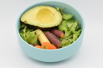Green Salad in a Blue Bowl on White Backgroun