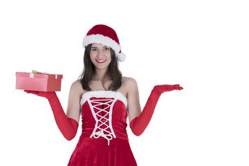 Christmas concept : Beautiful smiling young Asian woman in Santa Claus costume holding Christmas gift and open her hand for placing sign or product isolated on white background