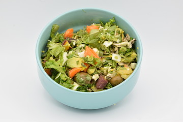 Green Salad in a Blue Bowl on White Backgroun
