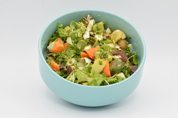 Green Salad in a Blue Bowl on White Backgroun