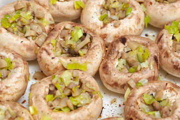 Edible white fresh raw champignon mushrooms, stuffed with vegetables