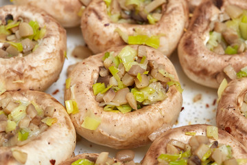 Edible white fresh raw champignon mushrooms, stuffed with vegetables