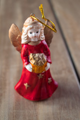 Fototapeta premium Angel with gift on wood texture