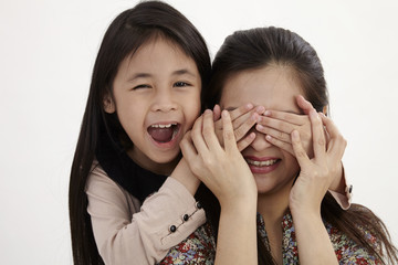 mother and daughter playing peek a boo