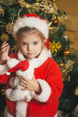 Fototapeta na wymiar Santa claus kid at Christmas tree.