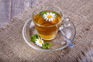 A cup of tea with chamomile on a wooden background. Alternative, traditional medicine. Healthy...