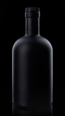 Black whiskey bottle on dark background