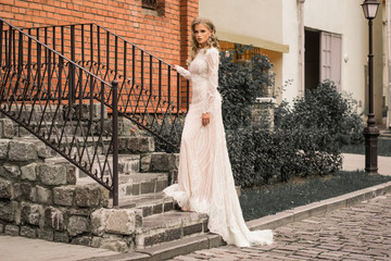 Bride thinking about happy future near modern building