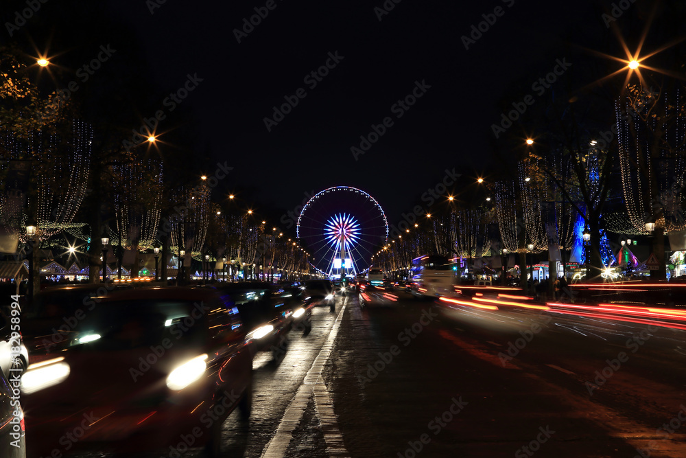 Wall mural Paris, France. Christmas illumination decorations on avenue Champs-Elysees and Big Wheel at Place de la Concorde at night