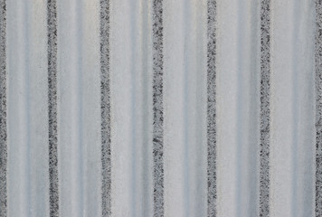Abstract background texture of light gray metal surface in pinstripe close-up