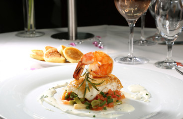 Seeteufel und Garnele mit Sauerrahmsoße auf Frühlinkslauch-Tomatengemüse und Kartoffelblini