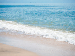 Fototapeta na wymiar The white foam of sea water wave on the beach,blurry light around,beauty by nature