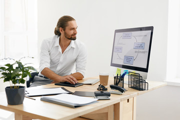 Young Business Man Working On Computer In Office.