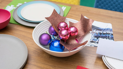 Christmas table set up with colorful plate and accessories.