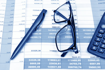 Business concept with calculator, pen,  glasses ,money and documents,tinted.Selective focus