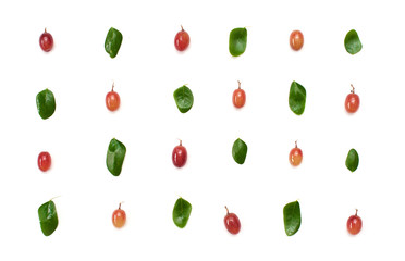 Seamless Pattern of red grape fruit and small green leaves isolated over white background..