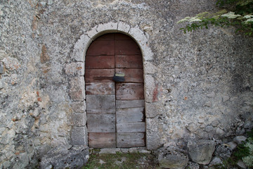 Fototapeta premium Entrance of an antique stone house in Italy 