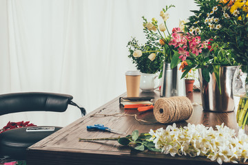 florist working table with flowers and tools