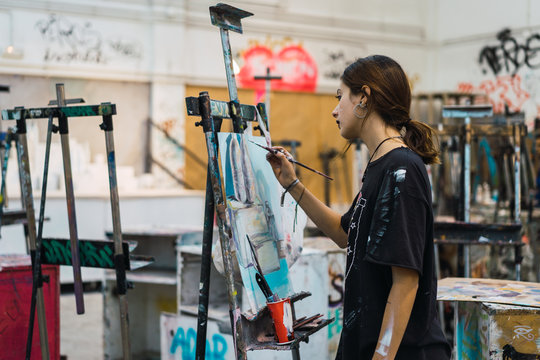 Creative woman painting in studio