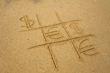 Tic-tac-toe game with playing euro and dollar symbols on sand. Concept of financial currency games