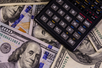 Modern calculator on a one hundred dollar bills