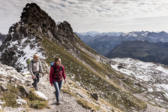 Germany, Bavaria, Oberstdorf, two hikers walking in alpine scenery