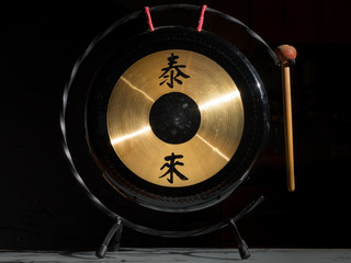 Closeup of a small chinese table gong - obrazy, fototapety, plakaty
