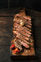 Sliced medium rare grilled  steak ribeye with salt, spices, and rosemary