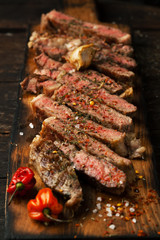 Sliced medium rare grilled  steak ribeye with salt, spices, and rosemary