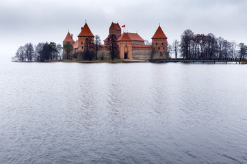 Trakai Island Castle nominated to World Heritage List, Trakai Historical National Park, Lithuania. Castle of red briks and leafless trees on the island on gloomy autumn day